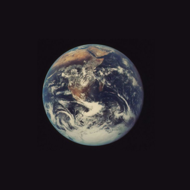 A photo of planet Earth taken from space, showing the continent of Africa, extensive cloud cover and the continent of Antarctica. The planet Earth is centred in the image against the black of outer space.